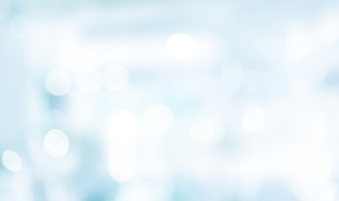 Soft light blue and white abstract bokeh background with blurred medical or office interior lighting.