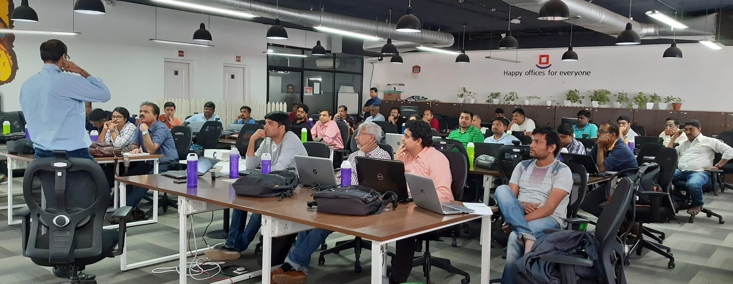 a man standing in front of a room full of people