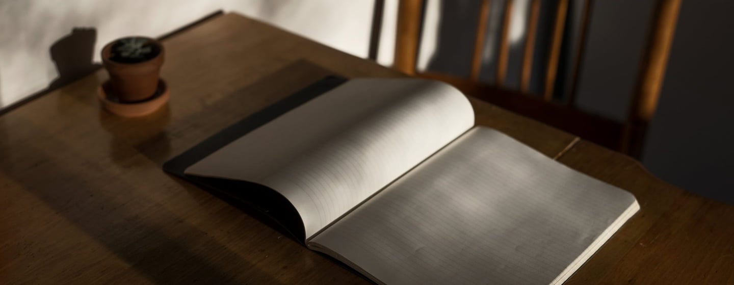 An open book on a desk representing academic study