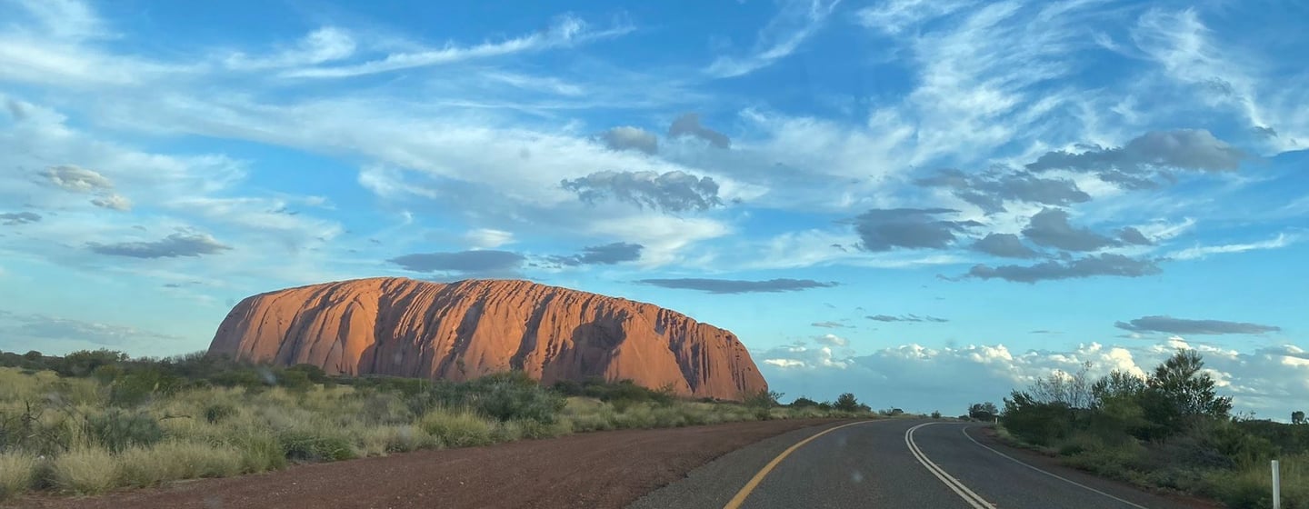 red rock in front of blue sky uluru