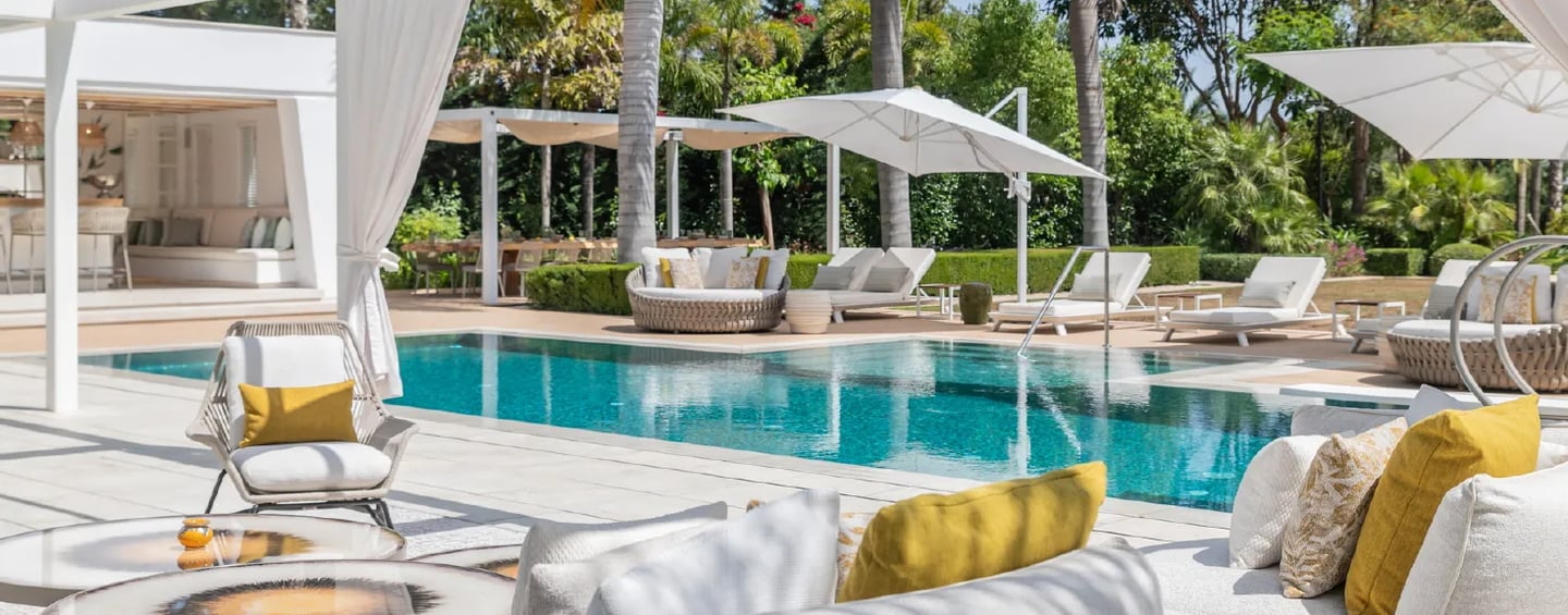 Villa Serenity poolside with daybeds and chic white pergola