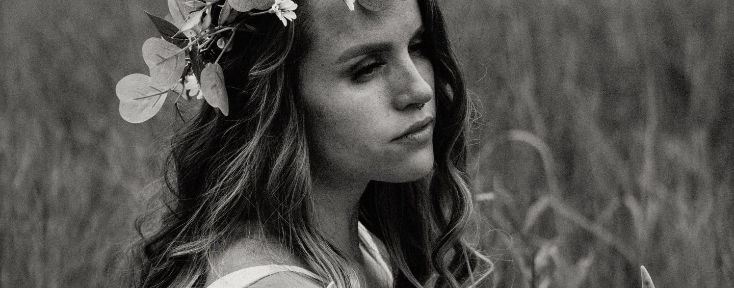 a woman in a dress with a deer skull headdress