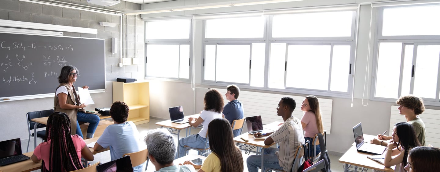 a classroom with a teacher and students in a classroom