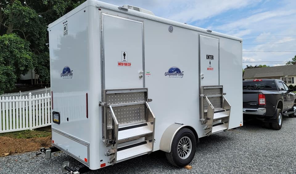 a 2 stall luxury restroom trailer heading out to an event being hauled with a truck