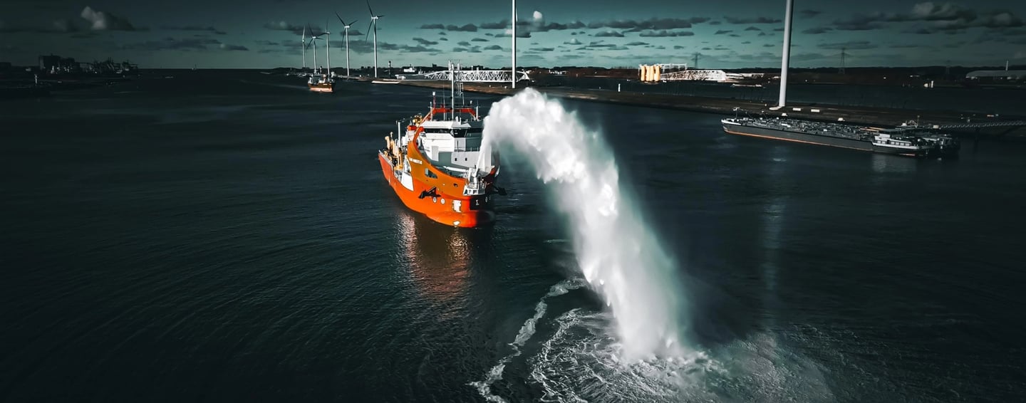 a boat in the water with a large spray of water