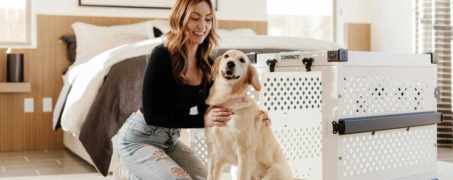 woman with golden retriever in modern bedroom