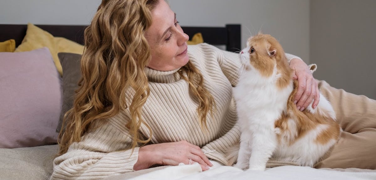 A woman holding a cat