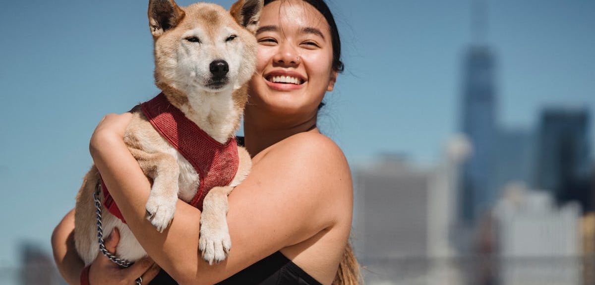A woman cuddling her dog