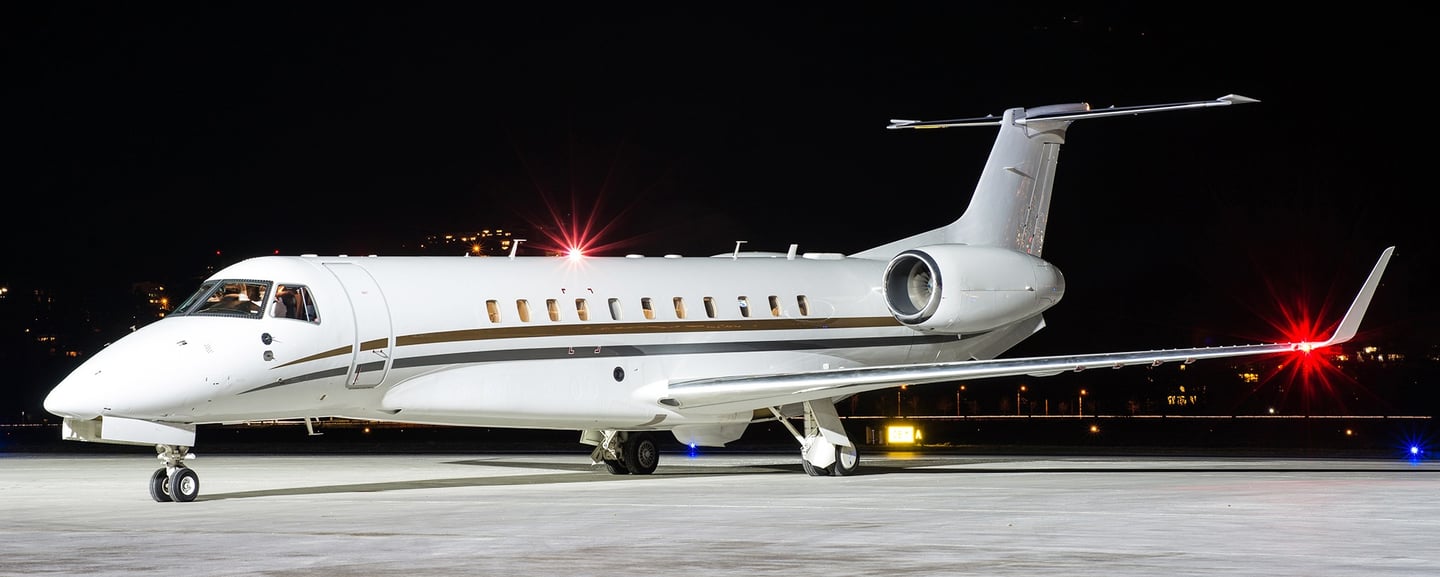 Embraer Legacy 650 sitting on the ramp at night