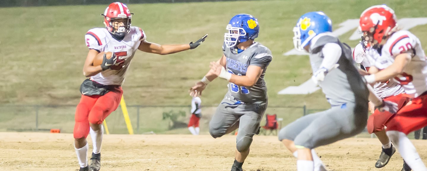 a football player is running with the ball