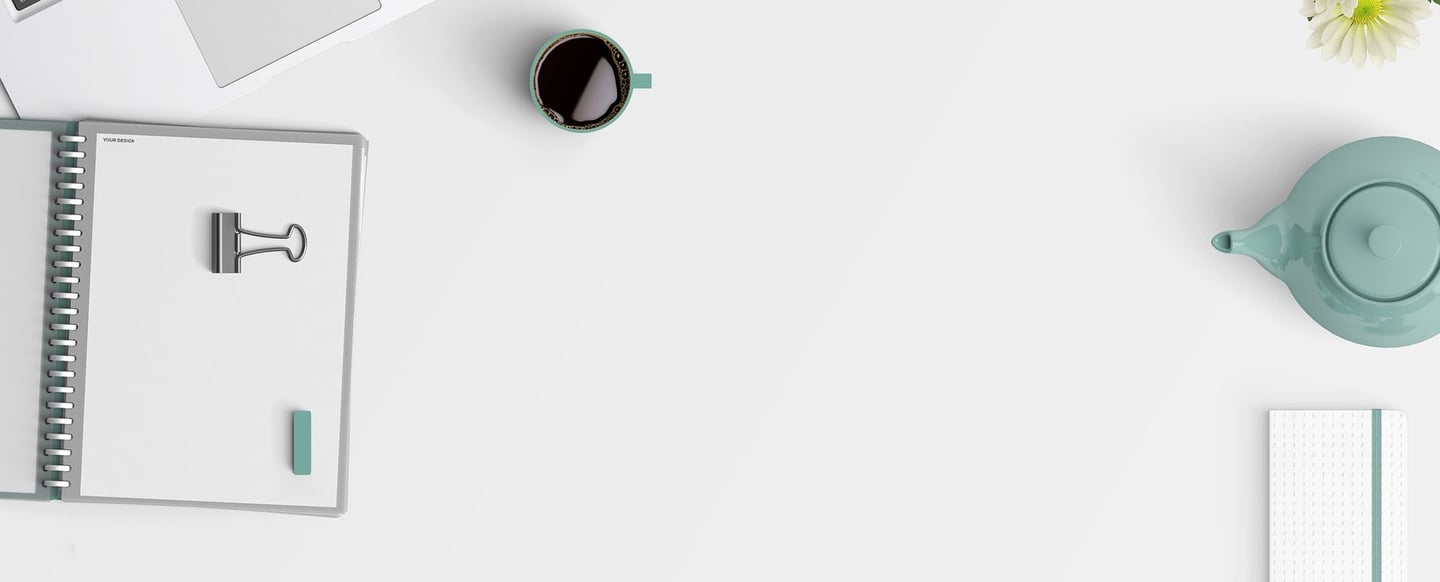 a laptop computer and a cup of coffee on a white table