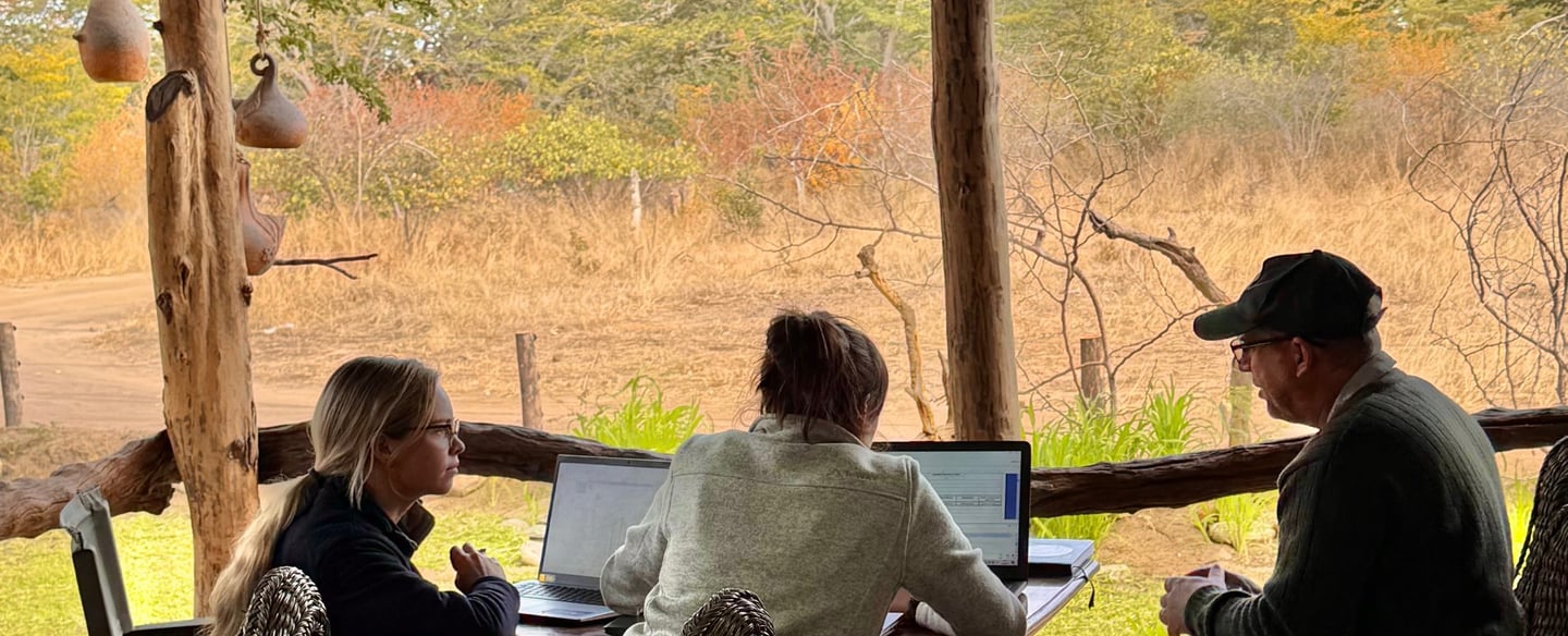 Researchers discussing work on their computers