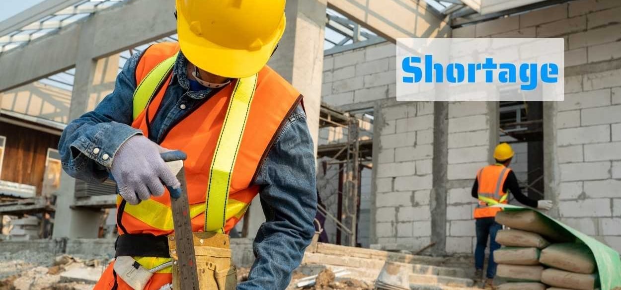 a construction worker in a yellow safety vest and a yellow helmet