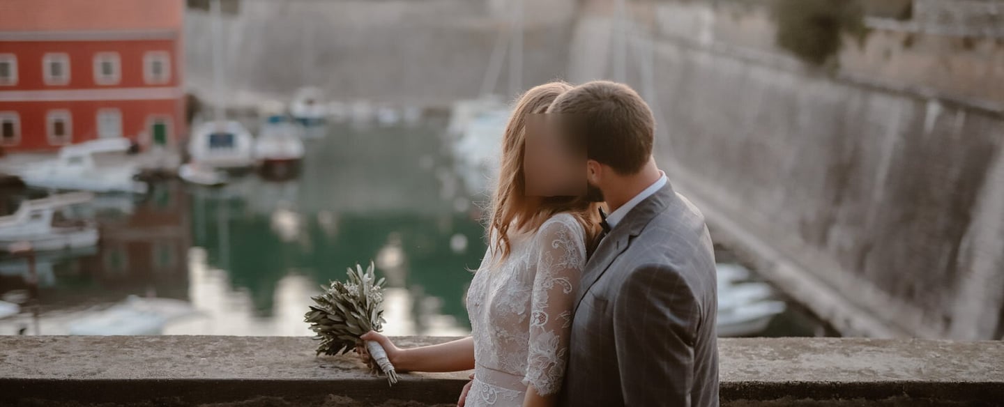 The photo shows a couple in love on their wedding day, overlooking the small city centre Port Fosa.