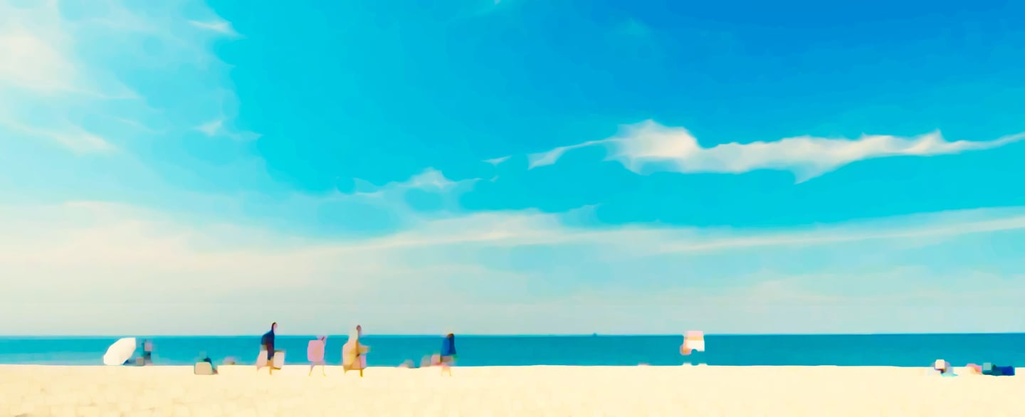 a beach with people standing on the sand