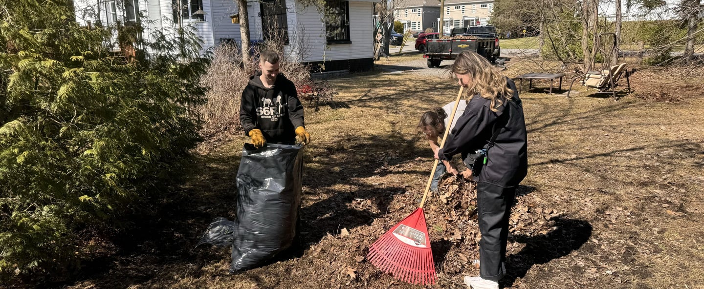 employees raking leaves with gcg truck in the backround