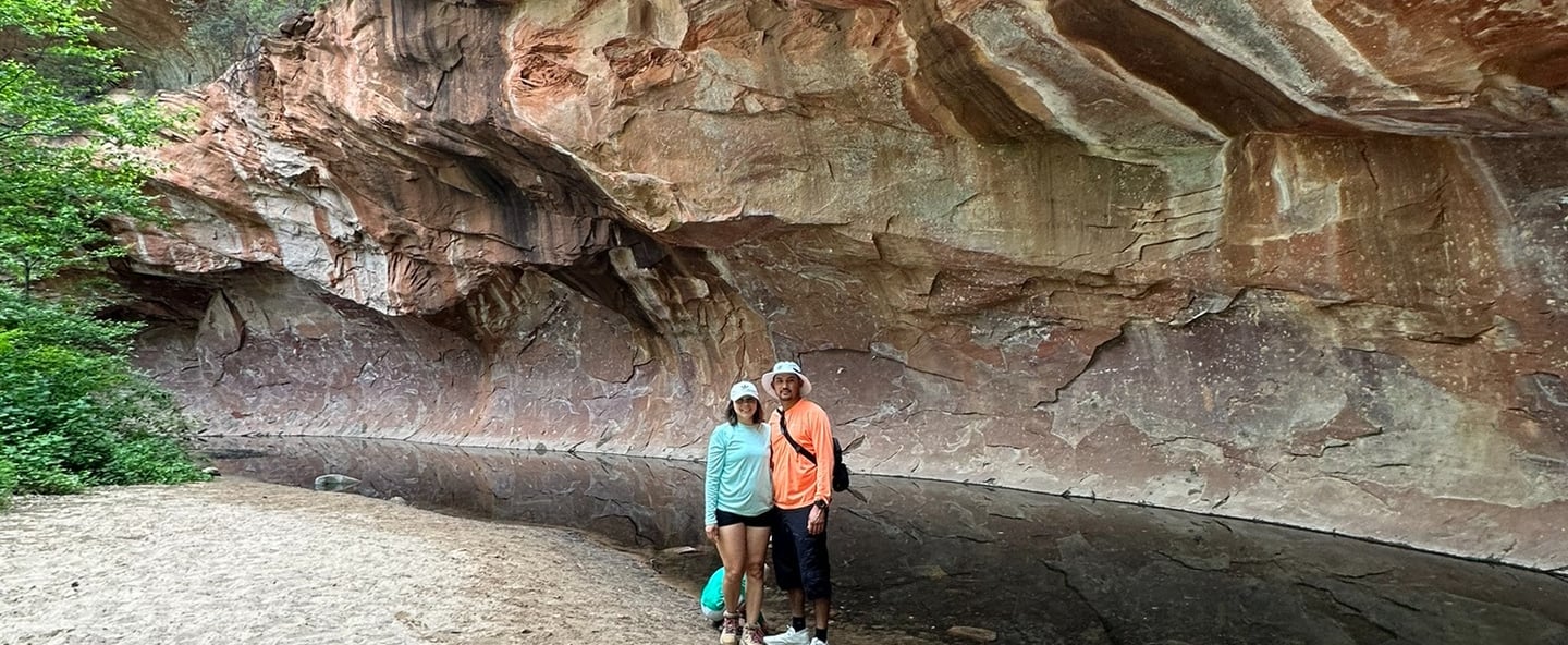 a couple of people standing in a cave in a cave