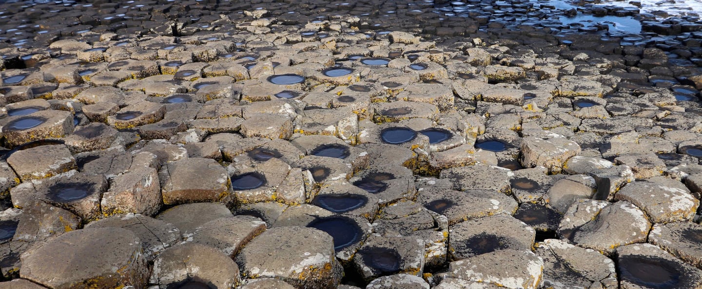 a large rock formation on the shore of a beach giants causeway