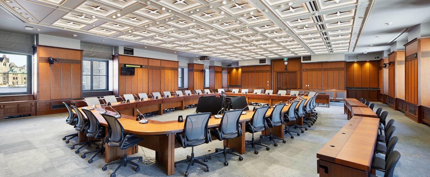 a conference room with a large wooden table and chairs
