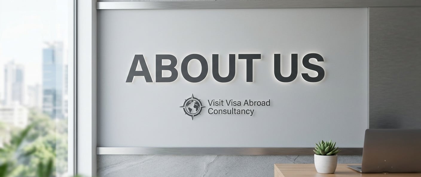 Modern office wall featuring the "About Us" sign and Visit Visa Abroad Consultancy logo.