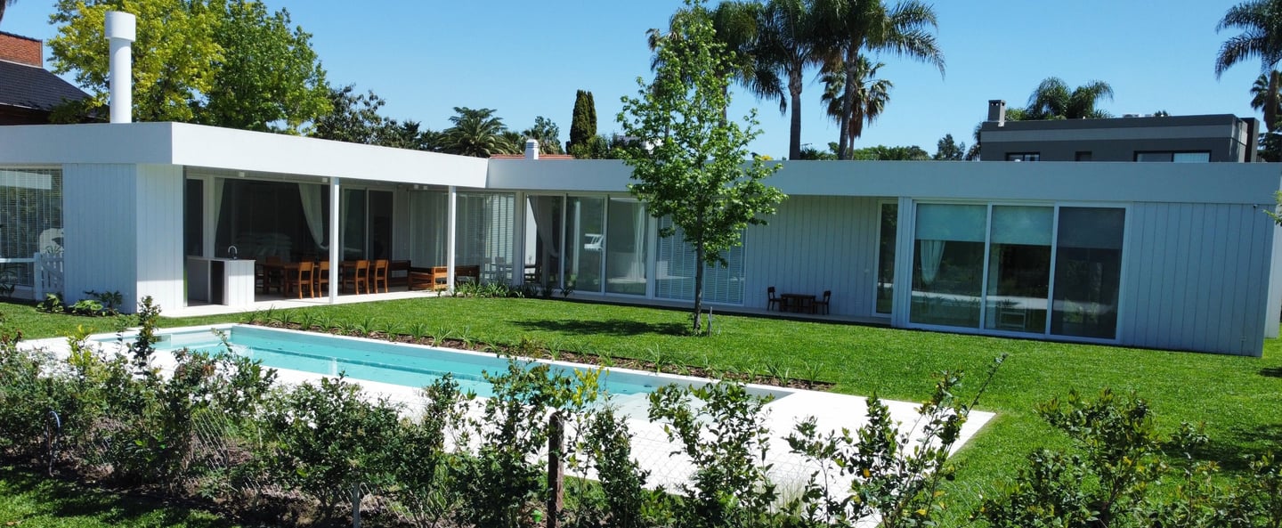 a pool in a backyard with a pool and a fence