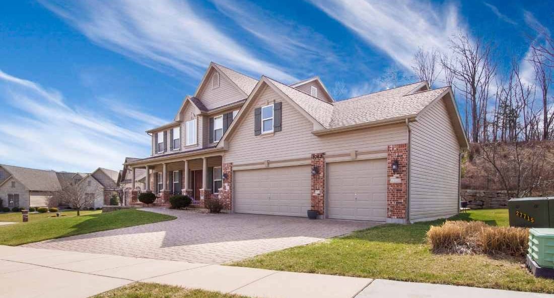 a house with a driveway and a garage door