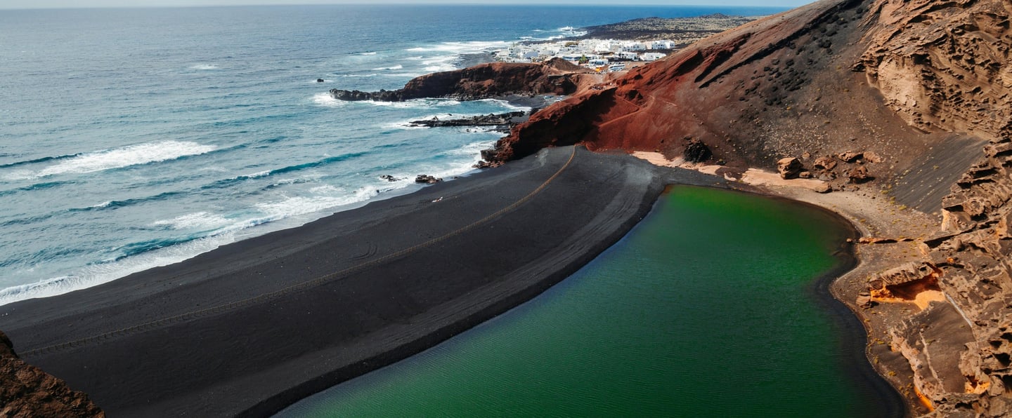 Lanzarote (Spain) a land carved over the Atlantic on fire and lava (photo by JP Files on Unsplash).