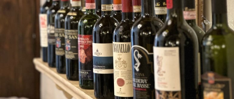 a row of bottles of wine on a shelf
