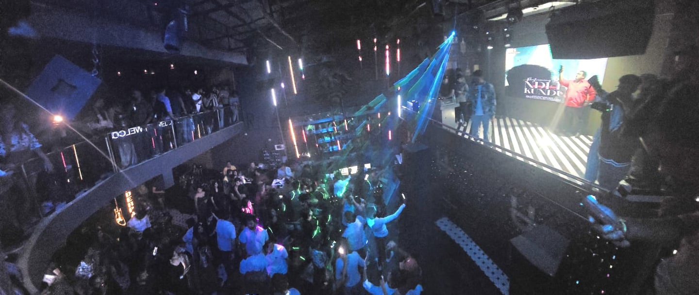 a crowd of people standing around a stage