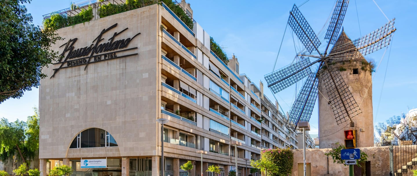 a windmill in front of a building in Mallorca