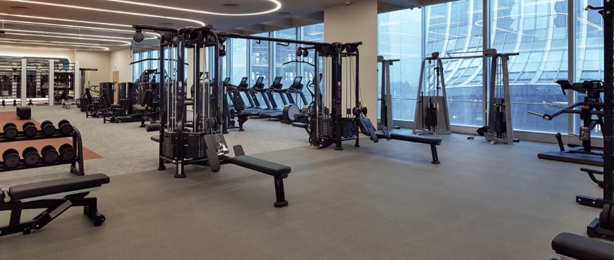 a gym with a lot of equipment and a bench