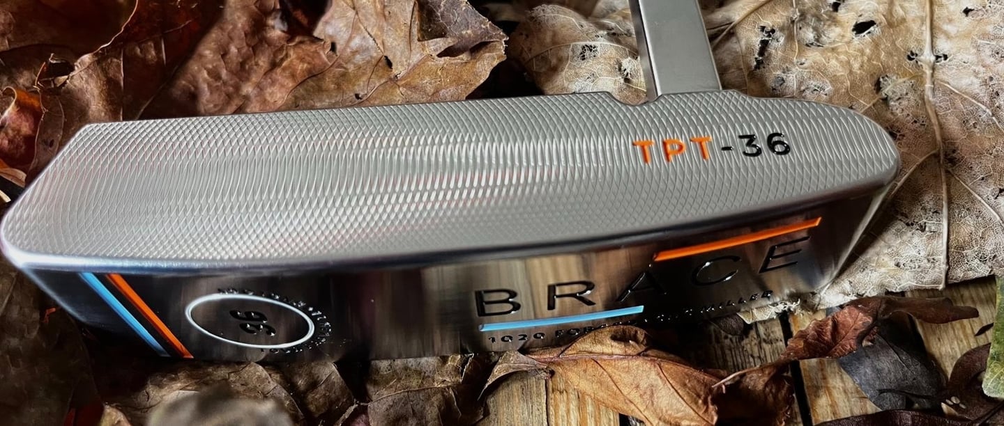 Brace forged golf putter on bed of Autumn leaves