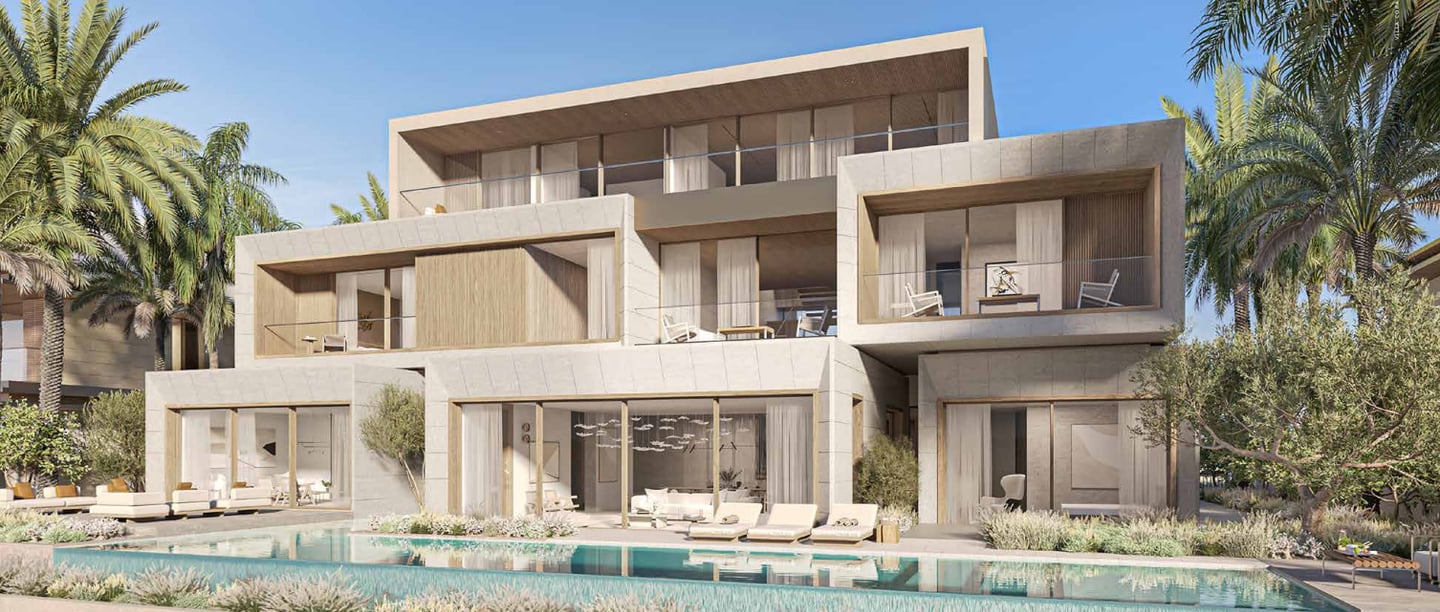 Palm Jebel Ali beach villa for sale, viewed from the water at dusk