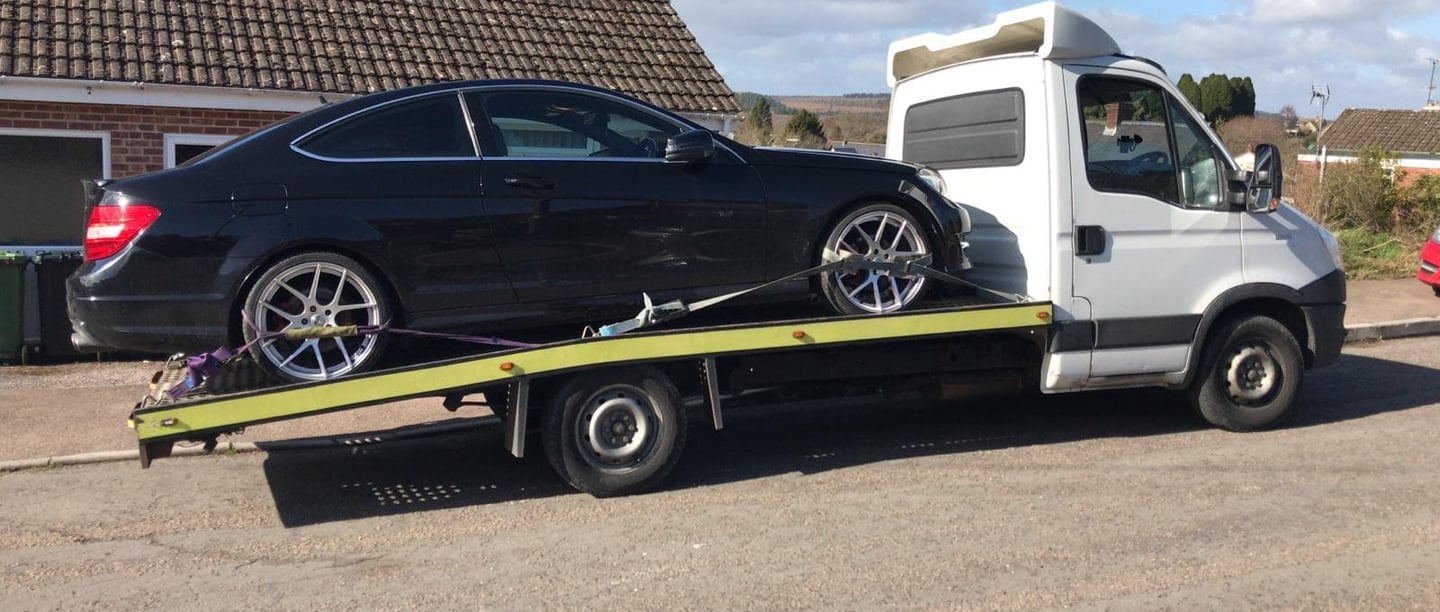 a car being towed by a tow truck