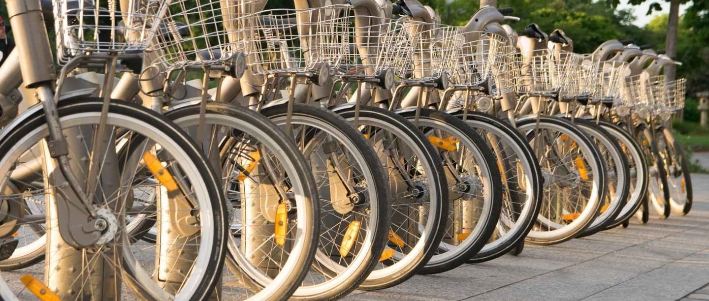 Bicycle rental station in Paris with rows of grey bikes lined up for visitors