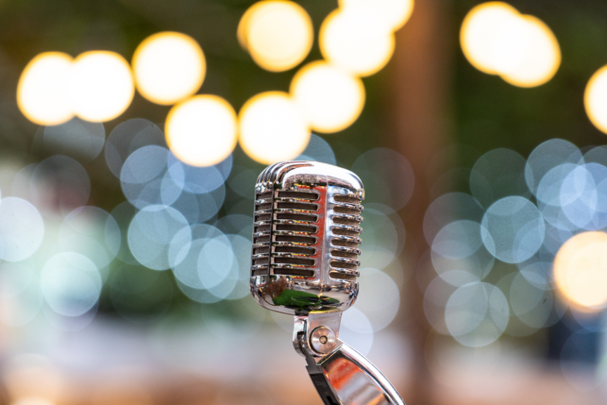 a microphone with a colourful blurry background lights