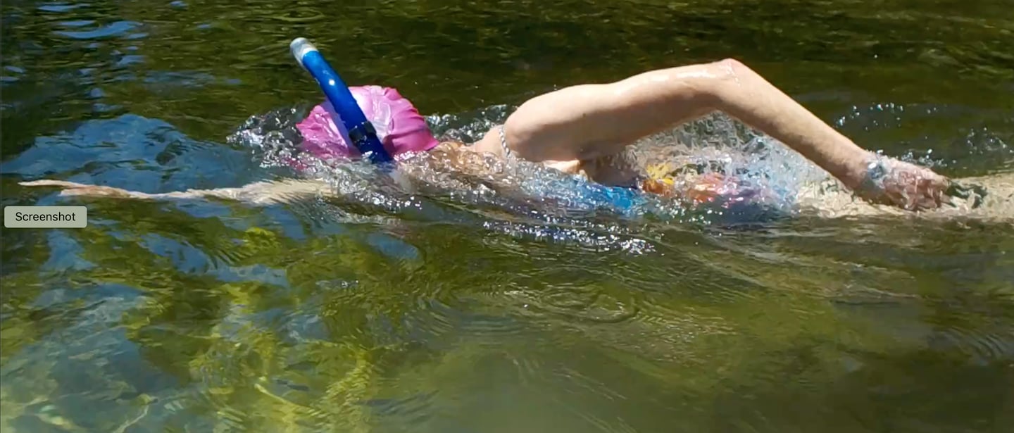 Susan Baur mid-stroke wearing a snorkeling mask. 