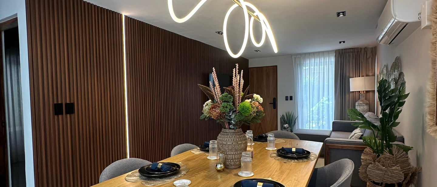 a dining room table with a wooden table and chairs and modern lighting