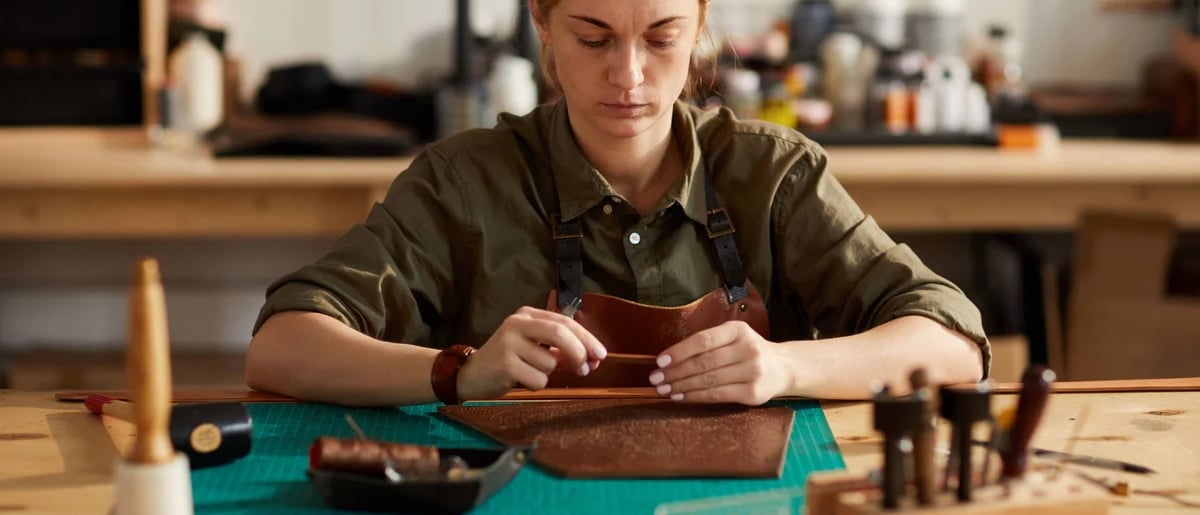 a woman in a green shirt and a brown wallet