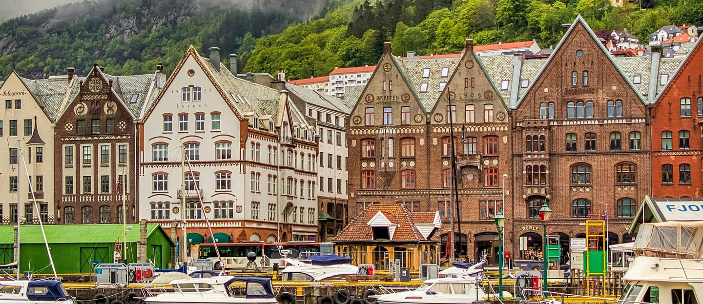 Boats and houses on coast of Bergen , Norway