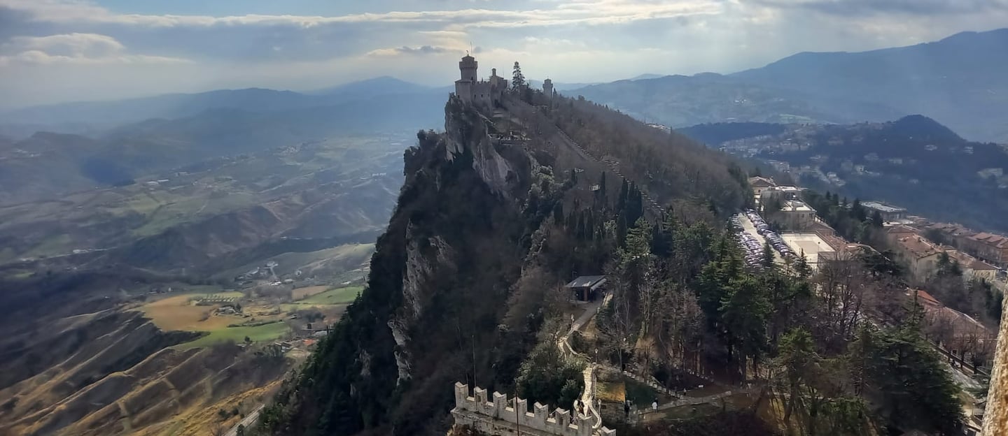 San Marino and the city wall and tower looking over to Italy