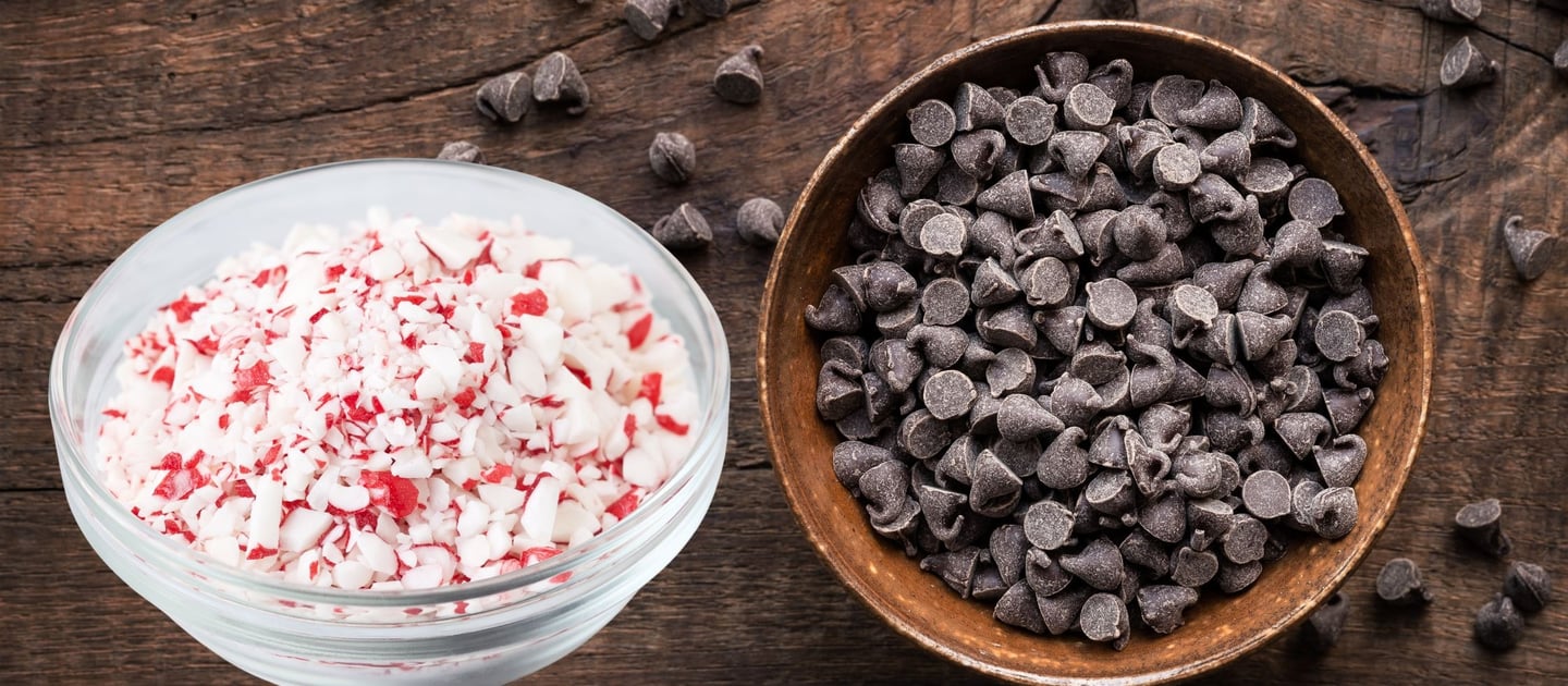 a bowl of chocolate chips and a bowl of candy cane