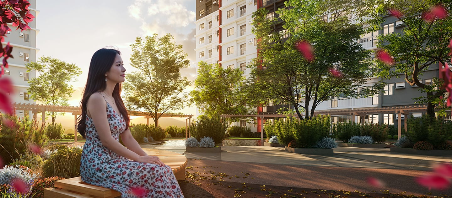 a woman sitting on a bench in a park