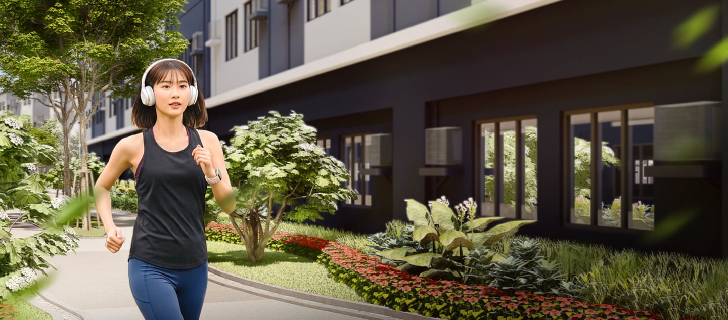 a woman in a black tank top and jeans walking down a sidewalk