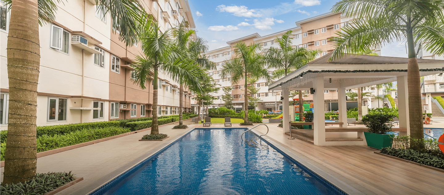 a pool with a gazeboar and palm trees