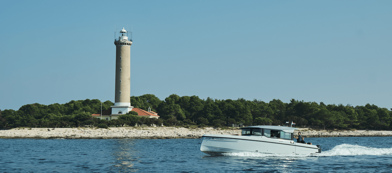 Just enjoy boat cruising the waves, passing by a lighthouse on the shore.