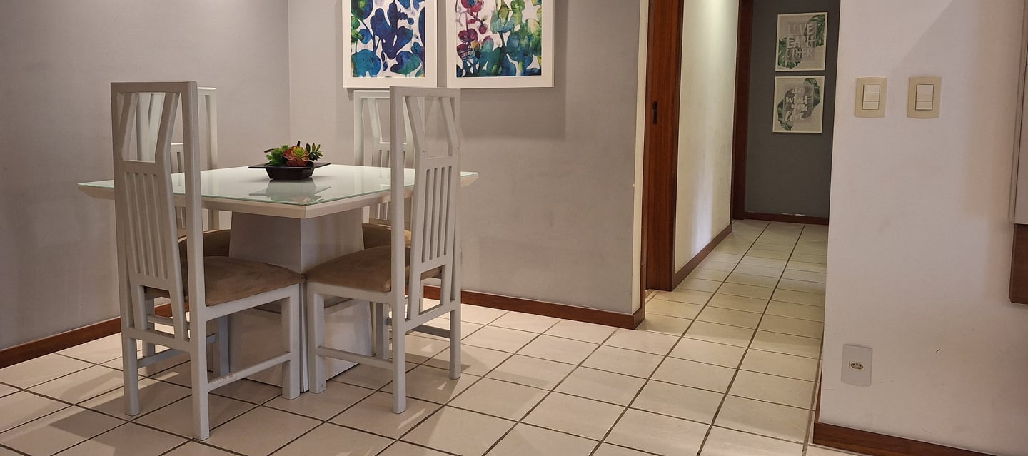 a dining room table with chairs and a lamp