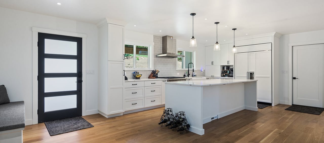 a kitchen with a large island and a wooden floor