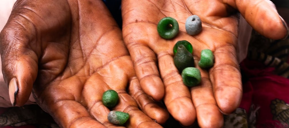 Old ladies hands holding hand made beads