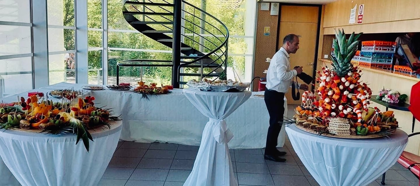 a table with a table with a lot of food and a spiral staircase